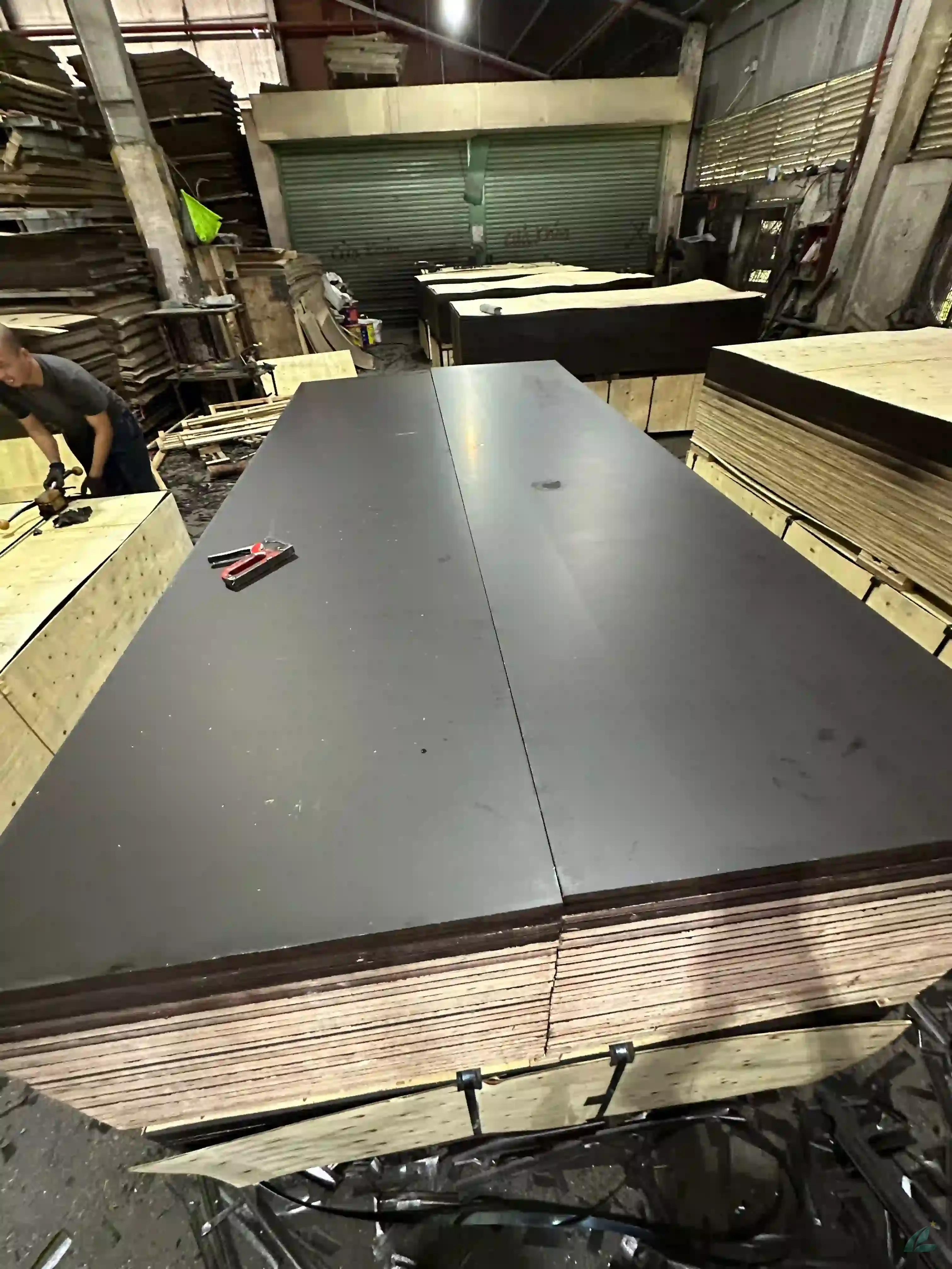 Vietnam film faced plywood black and brown phenolic panels stacked for export at HCPLY factory