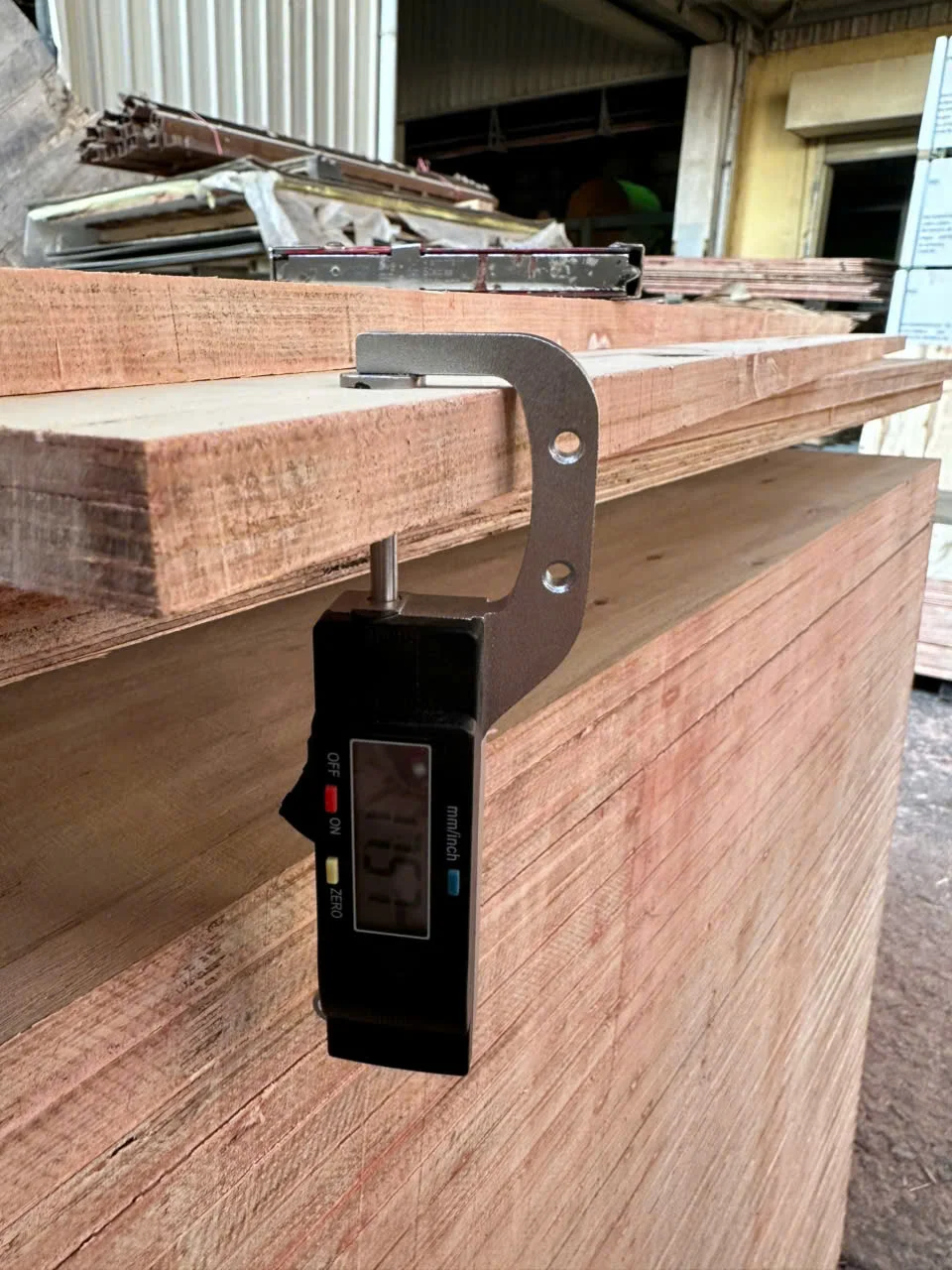 Vietnam plywood QC thickness measurement — calibrated caliper check before packing at HCPLY factory